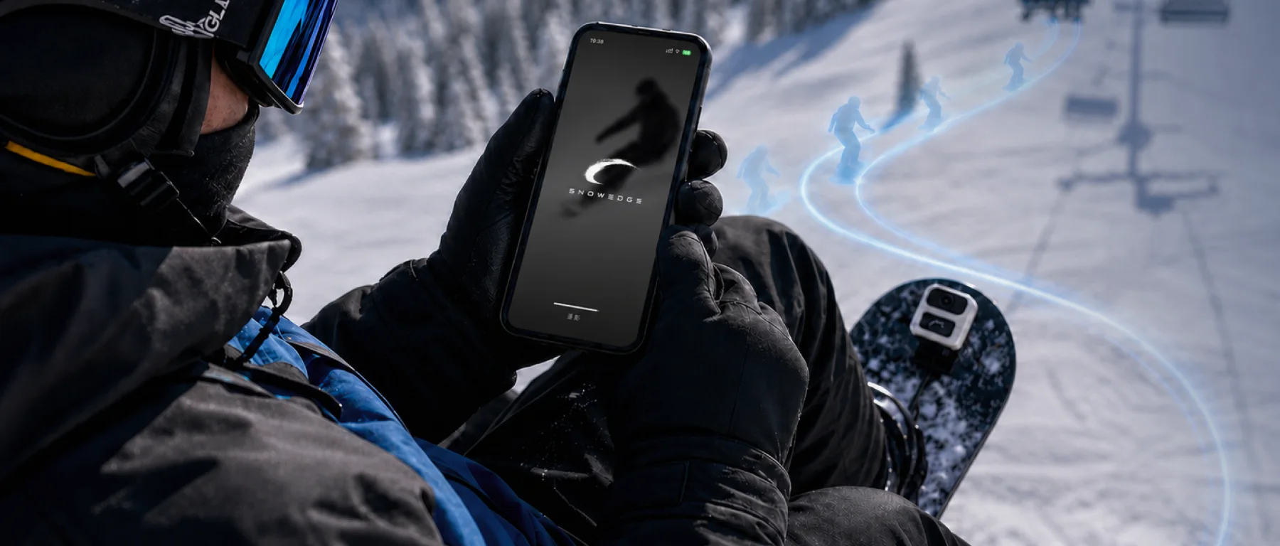 A rider on the chairlift opening SnowEdge, with the runs below traced in light